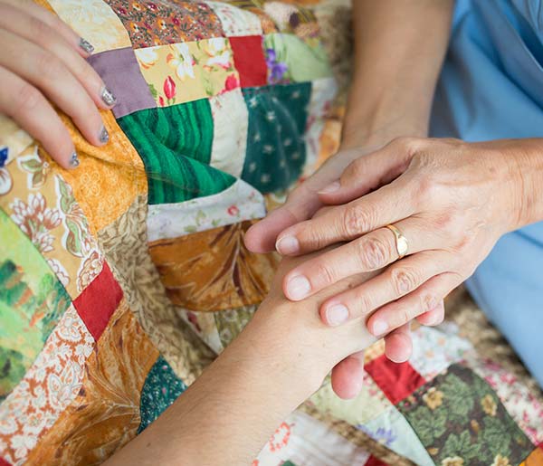 Visiting our hospices safety holding hands