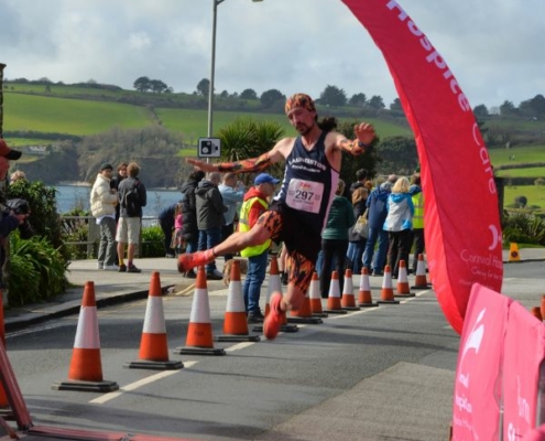 Run Falmouth Half Marathon Jumping across finish line